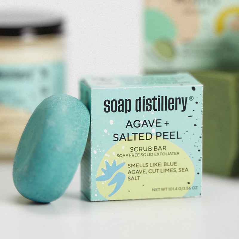 depth of field image of the agave + salted peel scrub bar in front of the agave candle and mint mojito soap