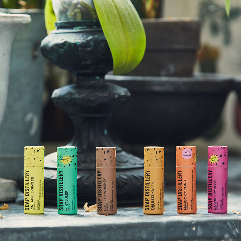 image of paperboard lip balm tubes in a colorful array outside on a concrete table