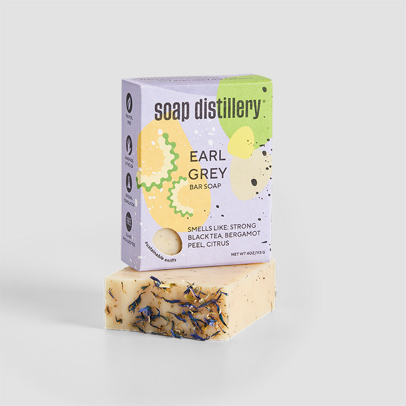 earl grey bar soap in colorful packaging against a grey background