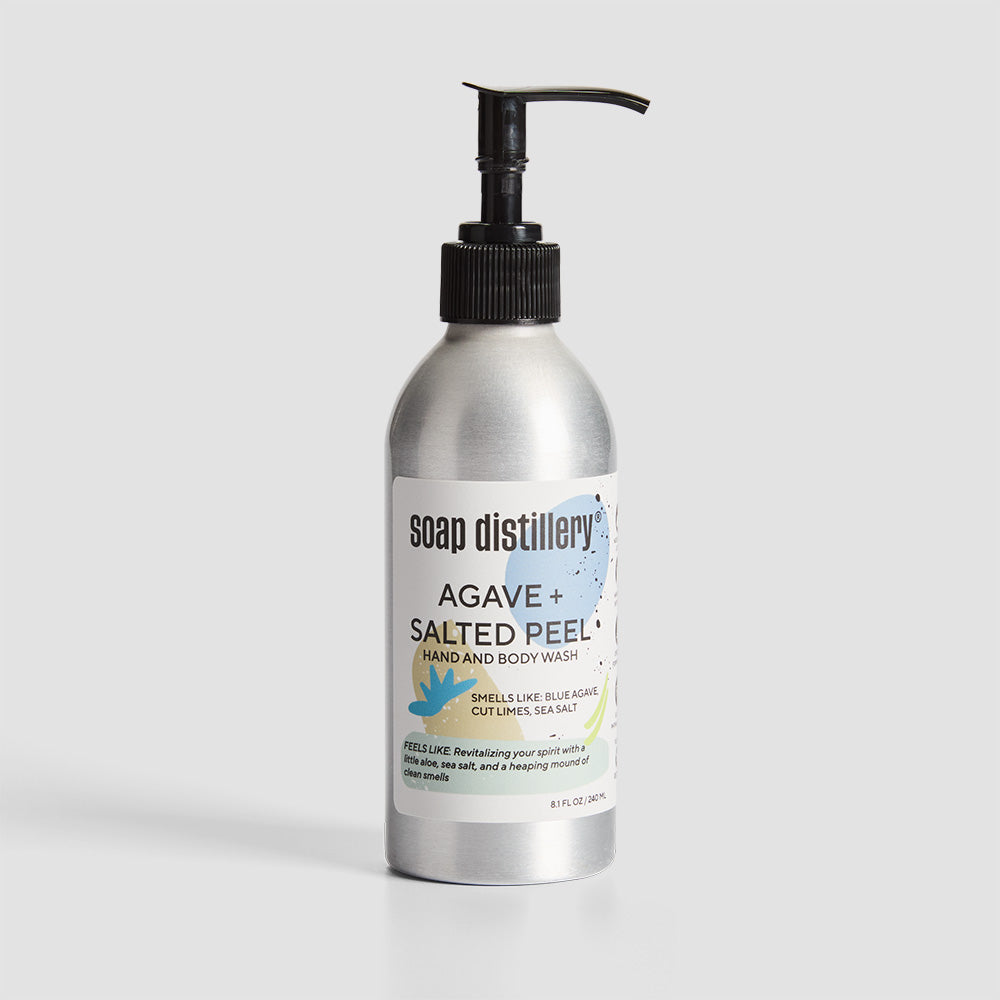 front shot of body wash in silver aluminum bottle with a white label with blue colors