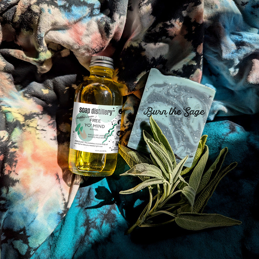 free yo mind body oil bathed in sunlight on a colorful tie die fabric with a burn the sage bar soap