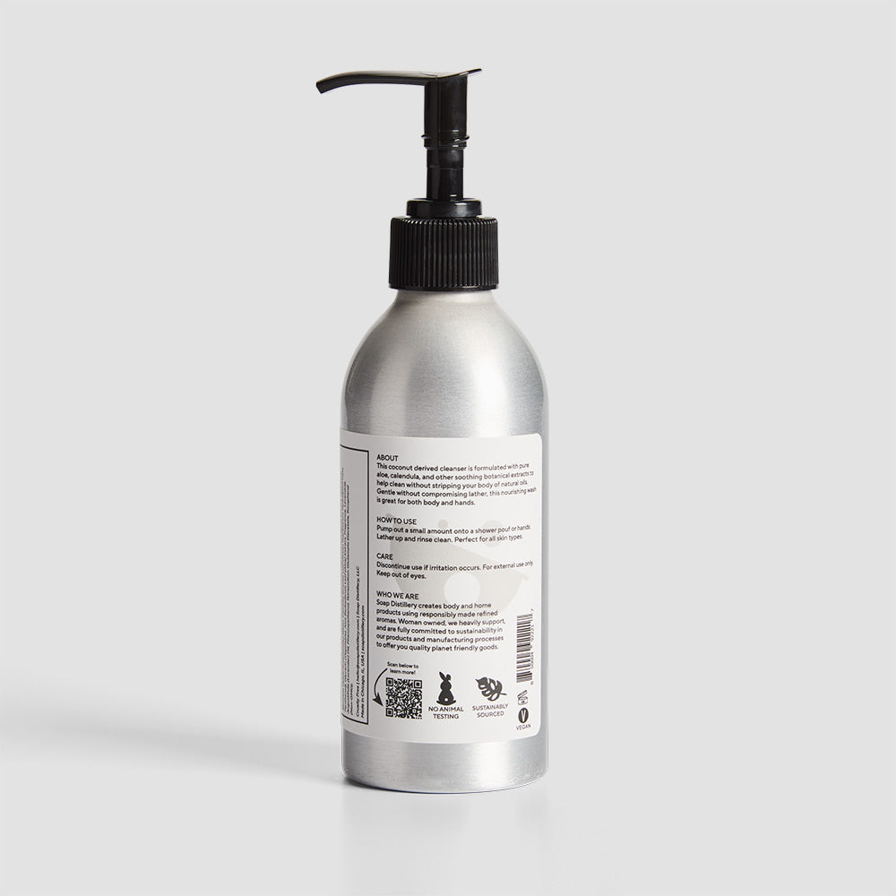 back shot of body wash in silver aluminum bottle with a white label with grey colors