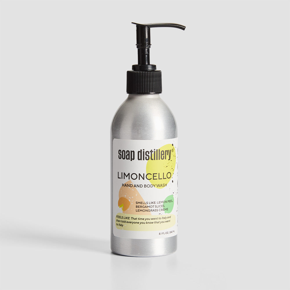 front shot of body wash in silver aluminum bottle with a white label with yellow colors