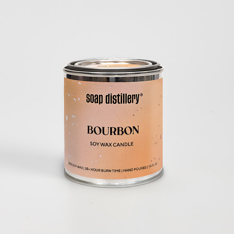 candle in a small paint can with an orange and tan label