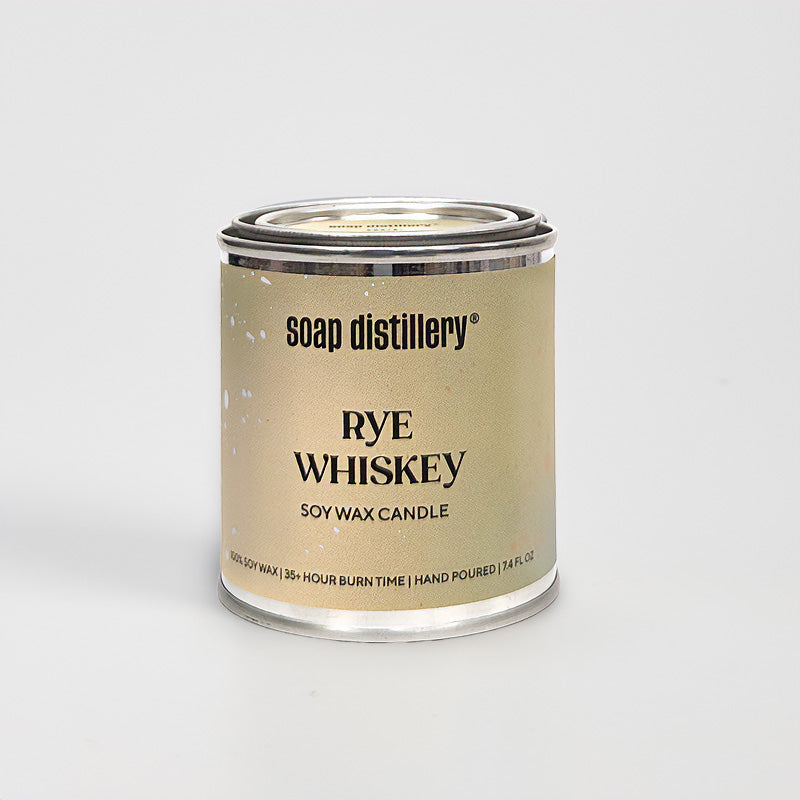 candle in a small paint can with a tan and olive green label