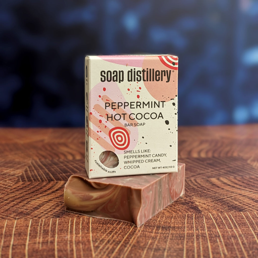 peppermint hot cocoa bar soap in colorful packaging against a blurred dark blue background