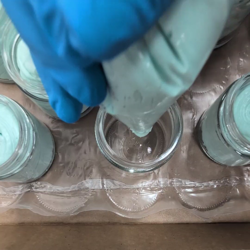 video of a jar being filled with a light green hand scrub