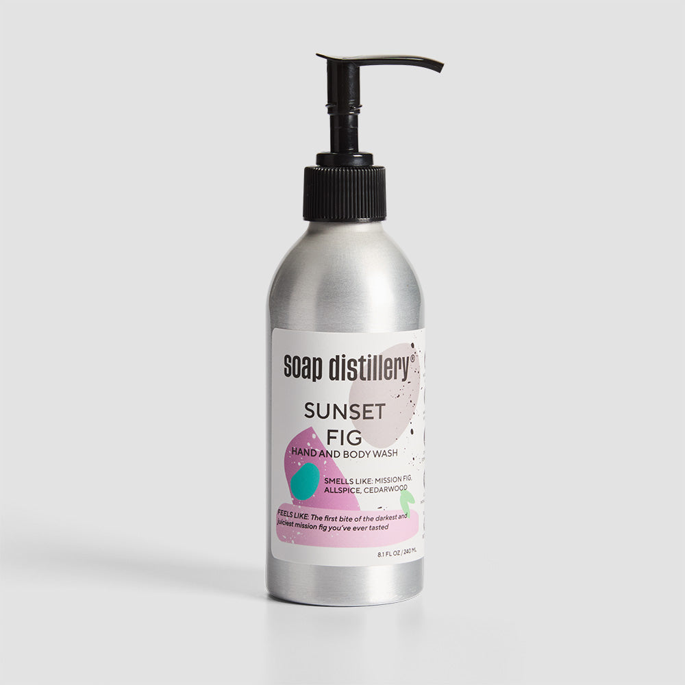 front shot of body wash in silver aluminum bottle with a white label with magenta colors