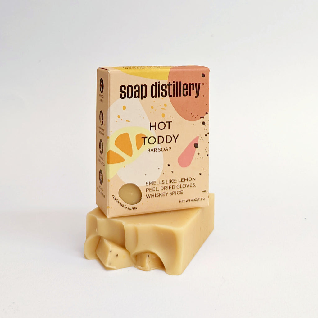 hot toddy bar soap in yellow multicolor packaging on a light grey background
