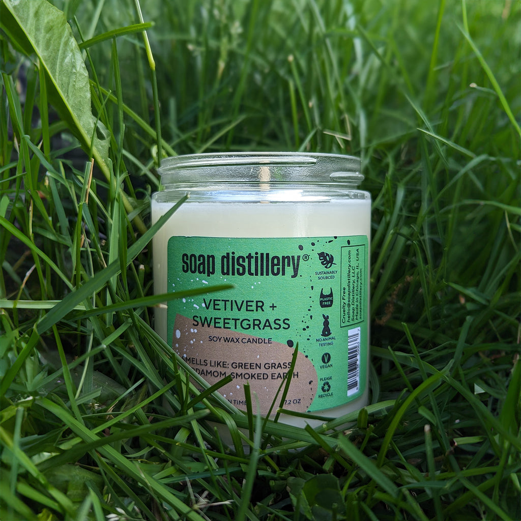 vetiver + sweetgrass candle sitting in grass